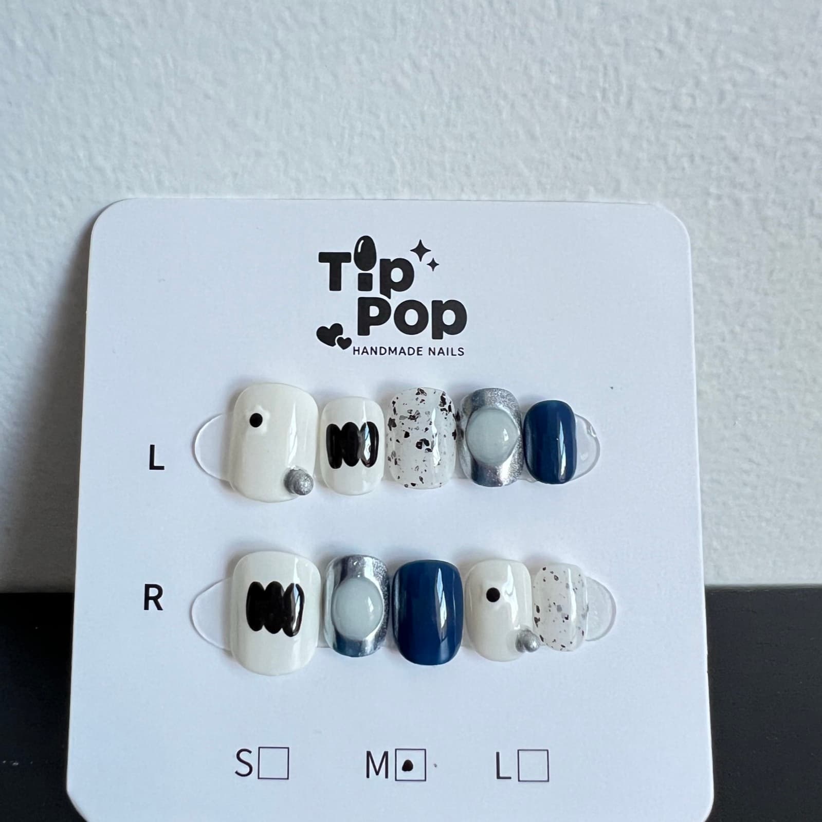 Abstract Navy Speckle press-on nail set on a TipPop Nails card