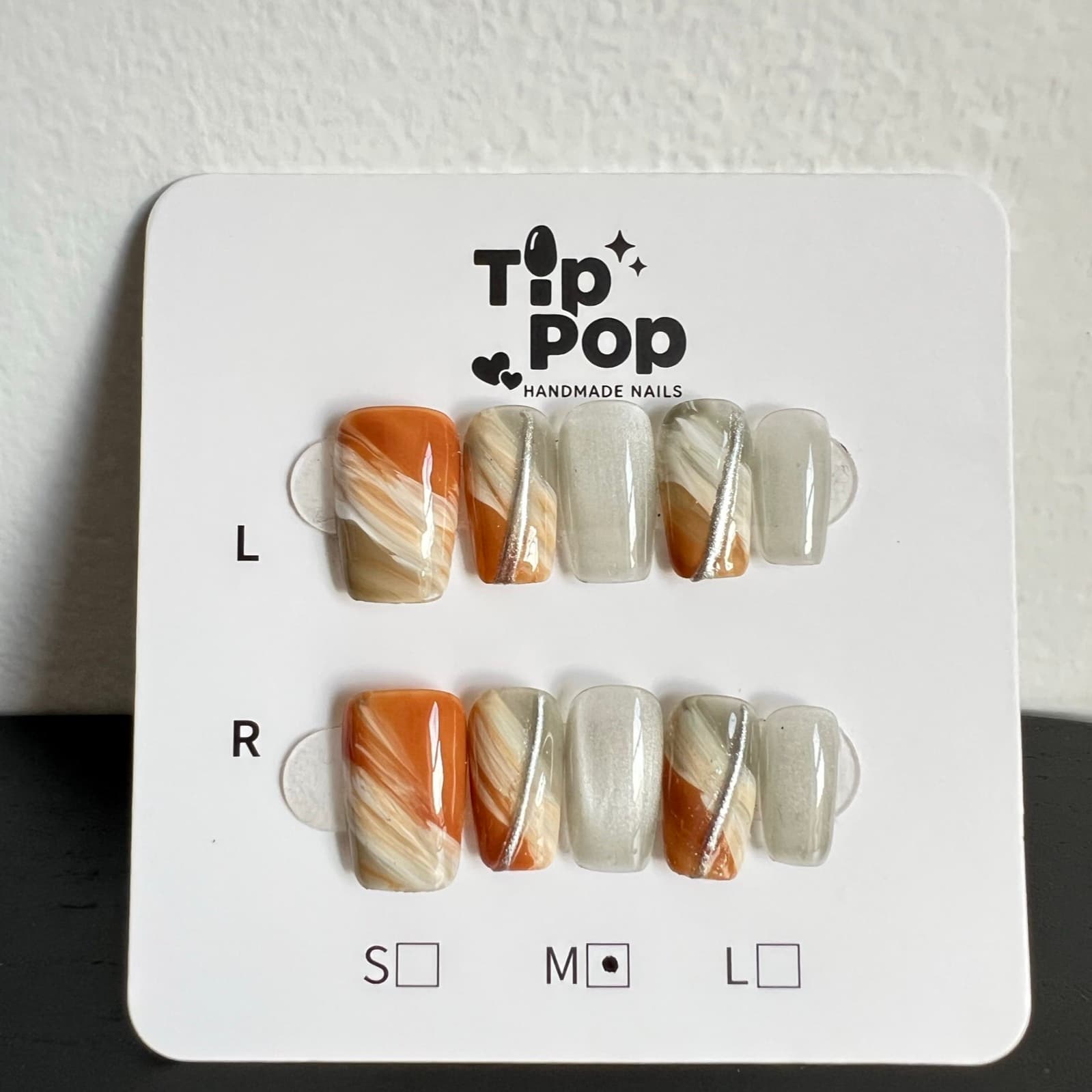 Amber Grey Marble press-on nail set on a TipPop Nails card