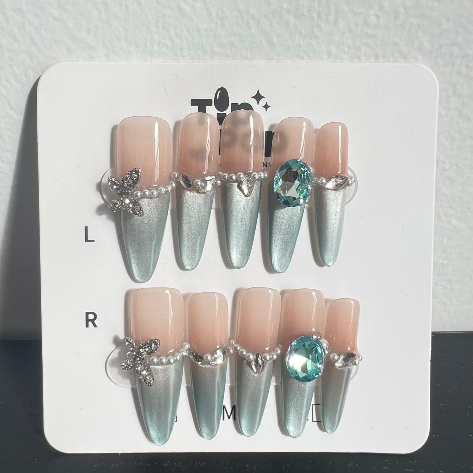 Aqua Gem Stiletto press-on nail set on a TipPop Nails card