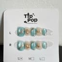 Aqua Gold Stone press-on nail set on a TipPop Nails card