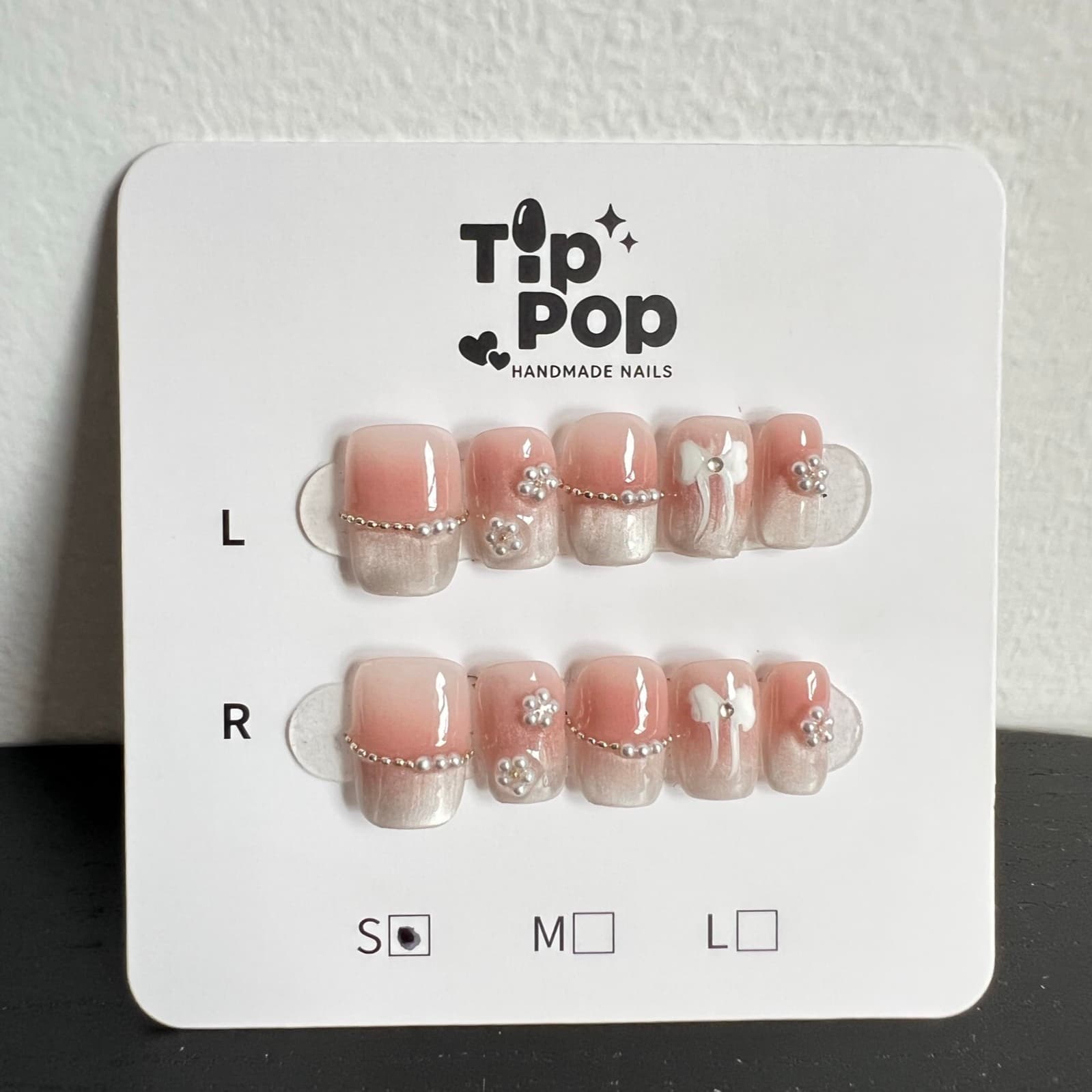 Pearl Bow French press-on nail set on a TipPop Nails card