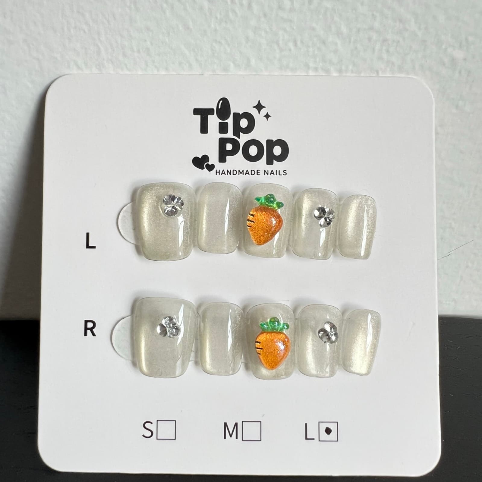 Pearl Carrot Sparkle press-on nail set on a TipPop Nails card