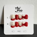 Ruby Bow Velvet press-on nail set on a TipPop Nails card