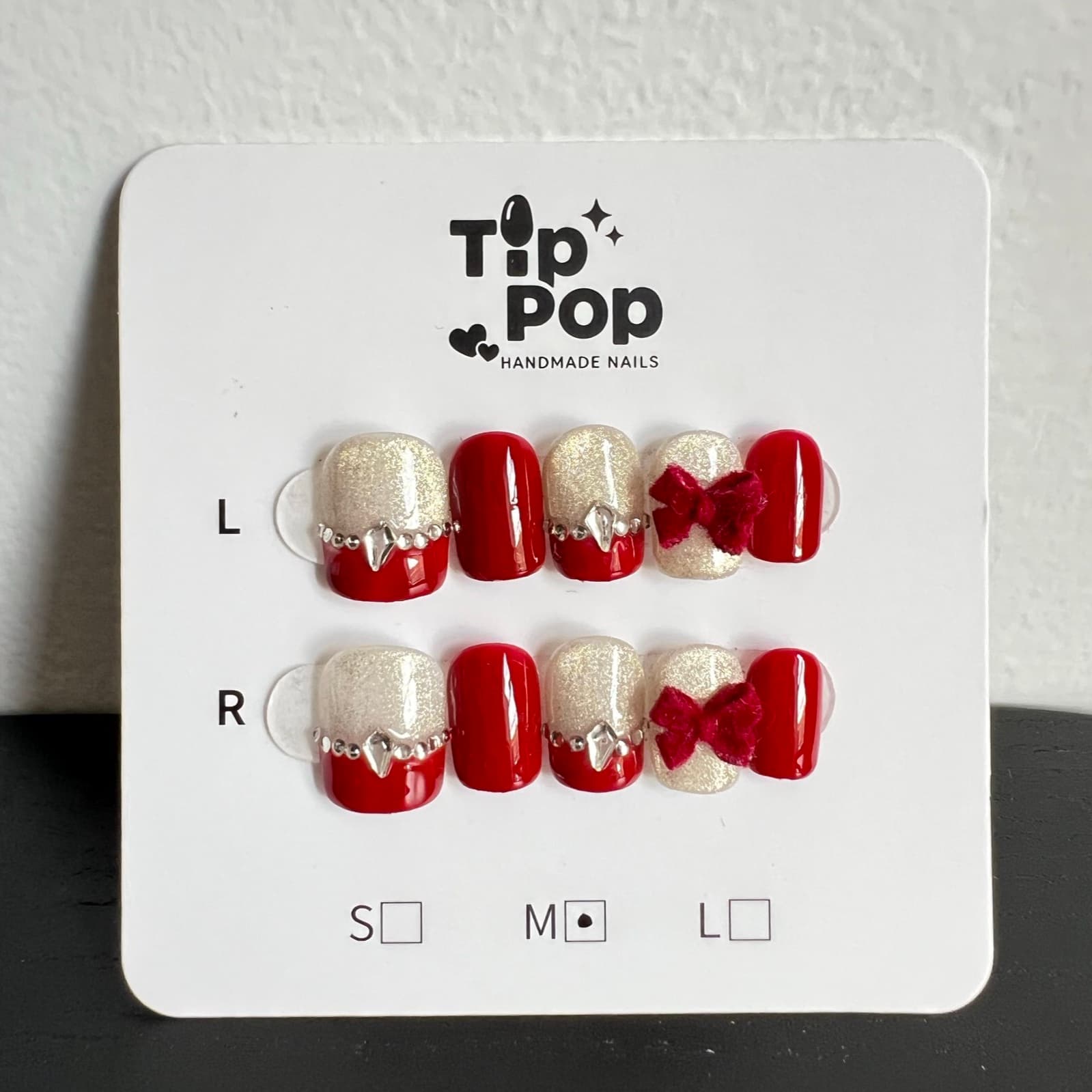 Ruby Bow Velvet press-on nail set on a TipPop Nails card