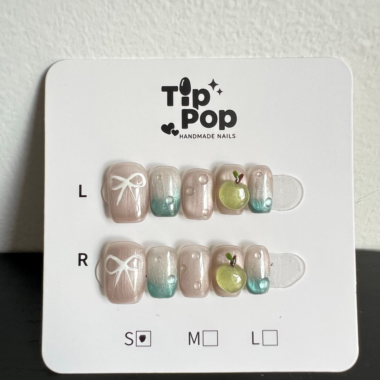 Sage Apple Bow press-on nail set on a TipPop Nails card